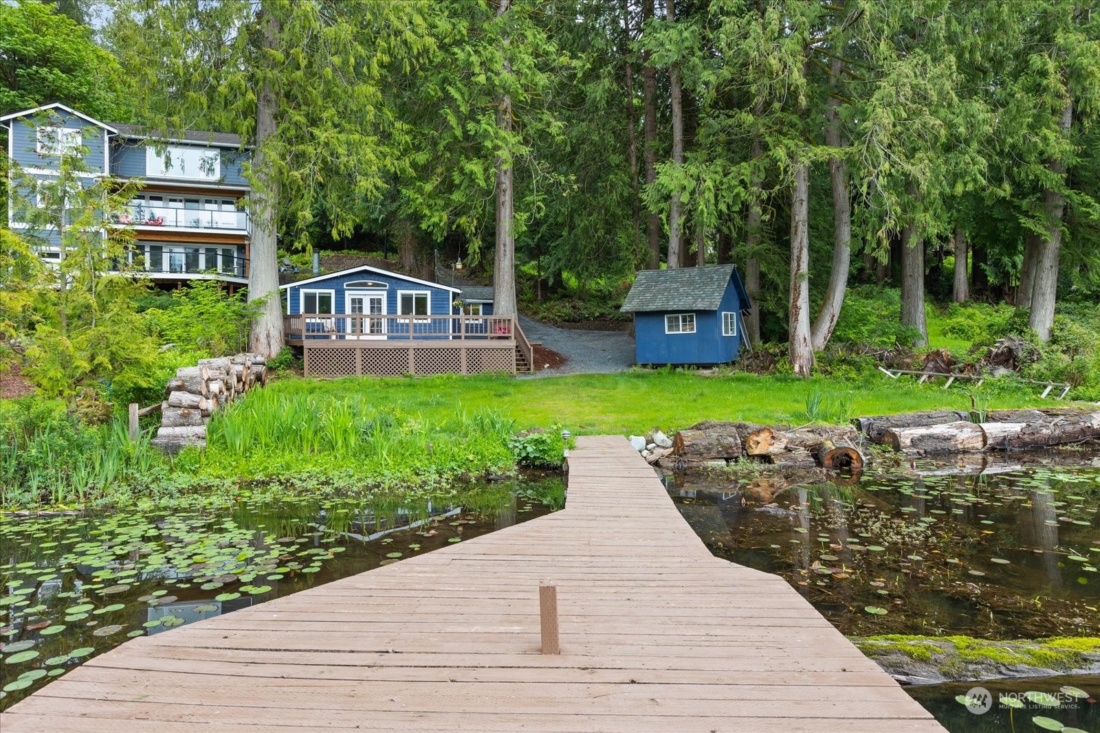 1024 South Lake Roesiger Road Snohomish, WA 98290 - Photo 26 of 35 a front view of a house with a yard and potted plants
