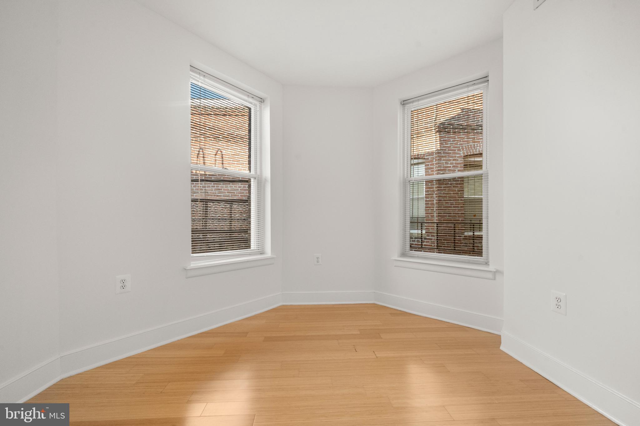 1106 Columbia Road Northwest, Unit 304 Washington, DC 20009 - Photo 25 of 25 an empty room with windows