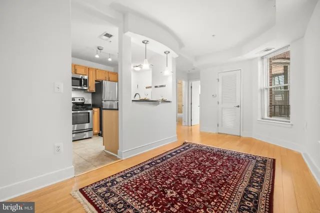 a view of a kitchen with wooden floor and a sink