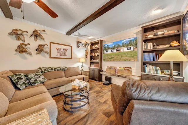 a kitchen with stainless steel appliances granite countertop a sink a stove and a wooden floors