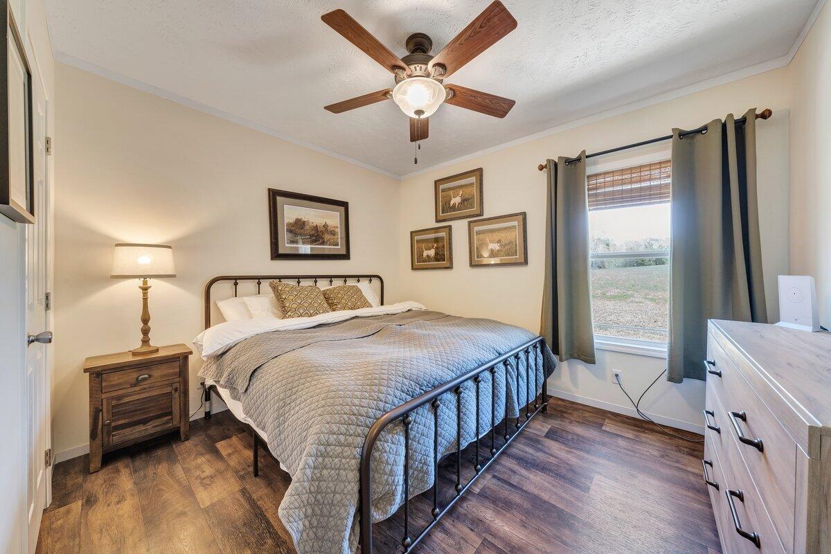 780 Adkins Road Penhook, VA 24137 - Photo 12 of 49 a bedroom with a bed and a large window