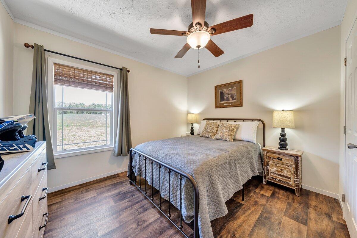 780 Adkins Road Penhook, VA 24137 - Photo 13 of 49 a bedroom with a bed chandelier and a window