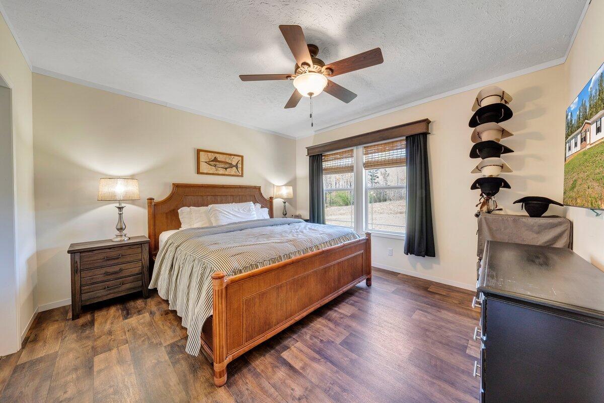 780 Adkins Road Penhook, VA 24137 - Photo 14 of 49 a spacious bedroom with a bed and a chandelier