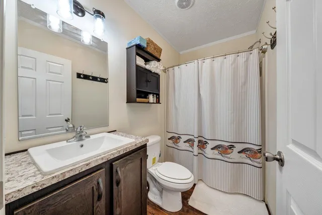 a spacious bedroom with a bed and a chandelier