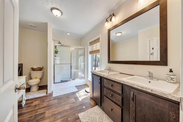 a bathroom with a granite countertop sink toilet and shower