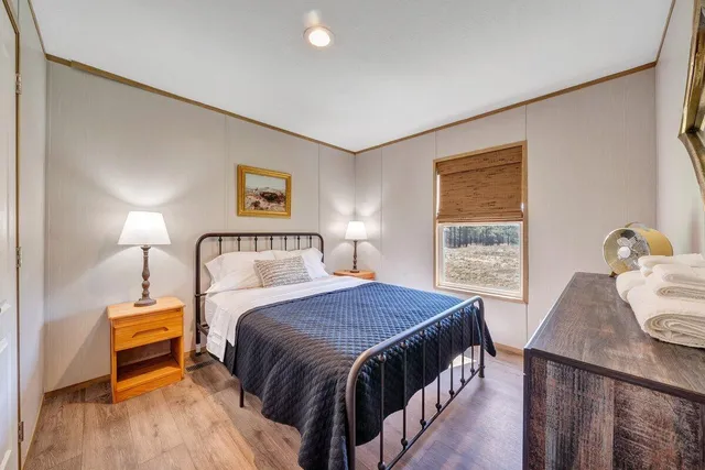 a bedroom with a bed and a night stand