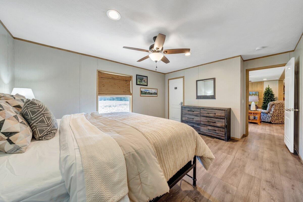 780 Adkins Road Penhook, VA 24137 - Photo 30 of 49 a bedroom with a bed and a chandelier