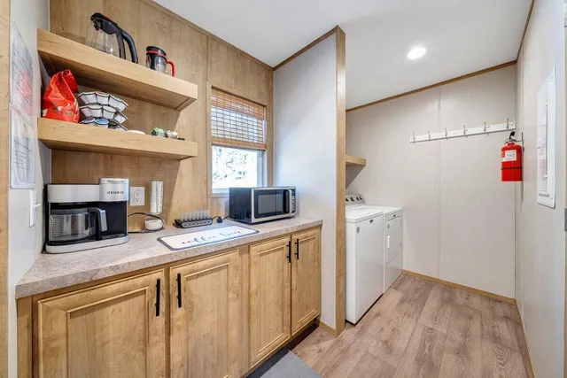 a bathroom with a double vanity sink a mirror and a bathtub
