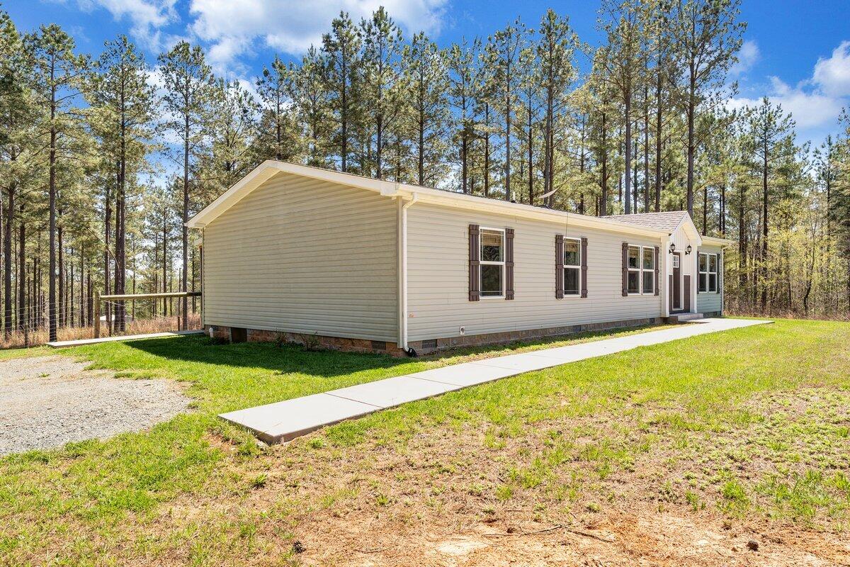 780 Adkins Road Penhook, VA 24137 - Photo 3 of 49 a view of a house with backyard and trees