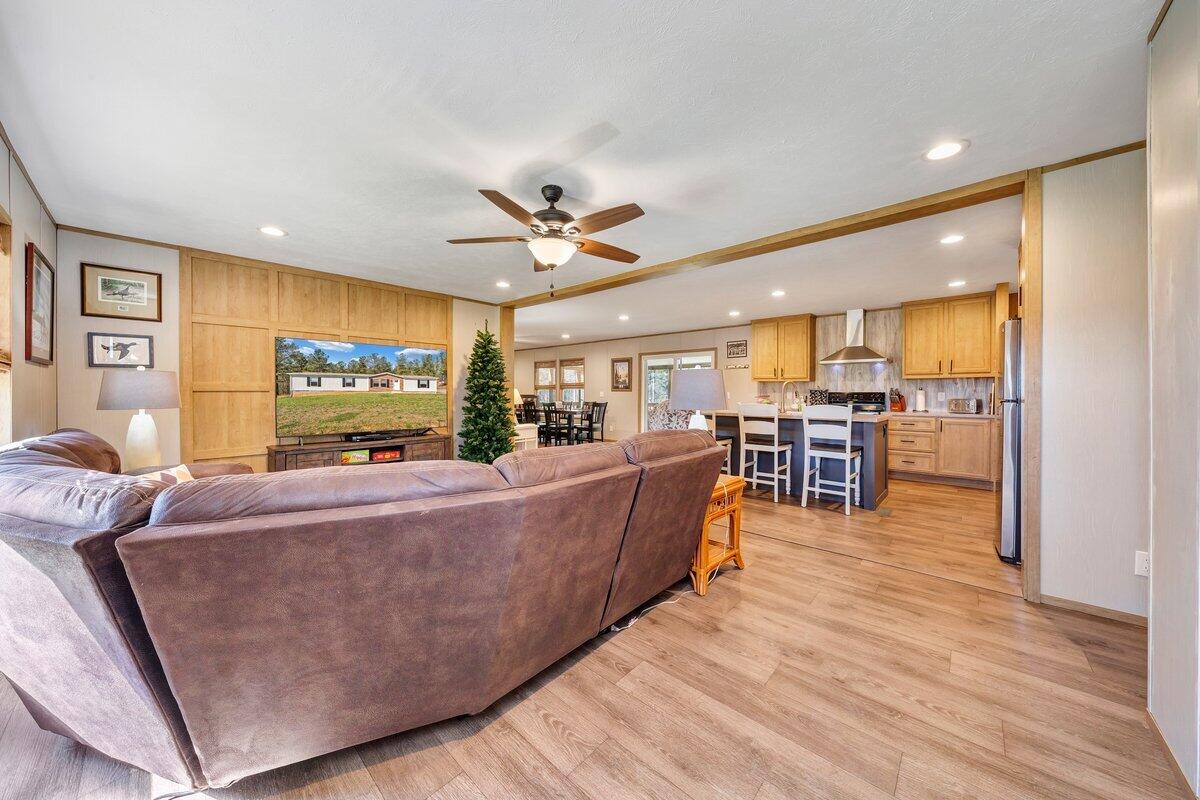 780 Adkins Road Penhook, VA 24137 - Photo 6 of 49 a living room with furniture and a flat screen tv
