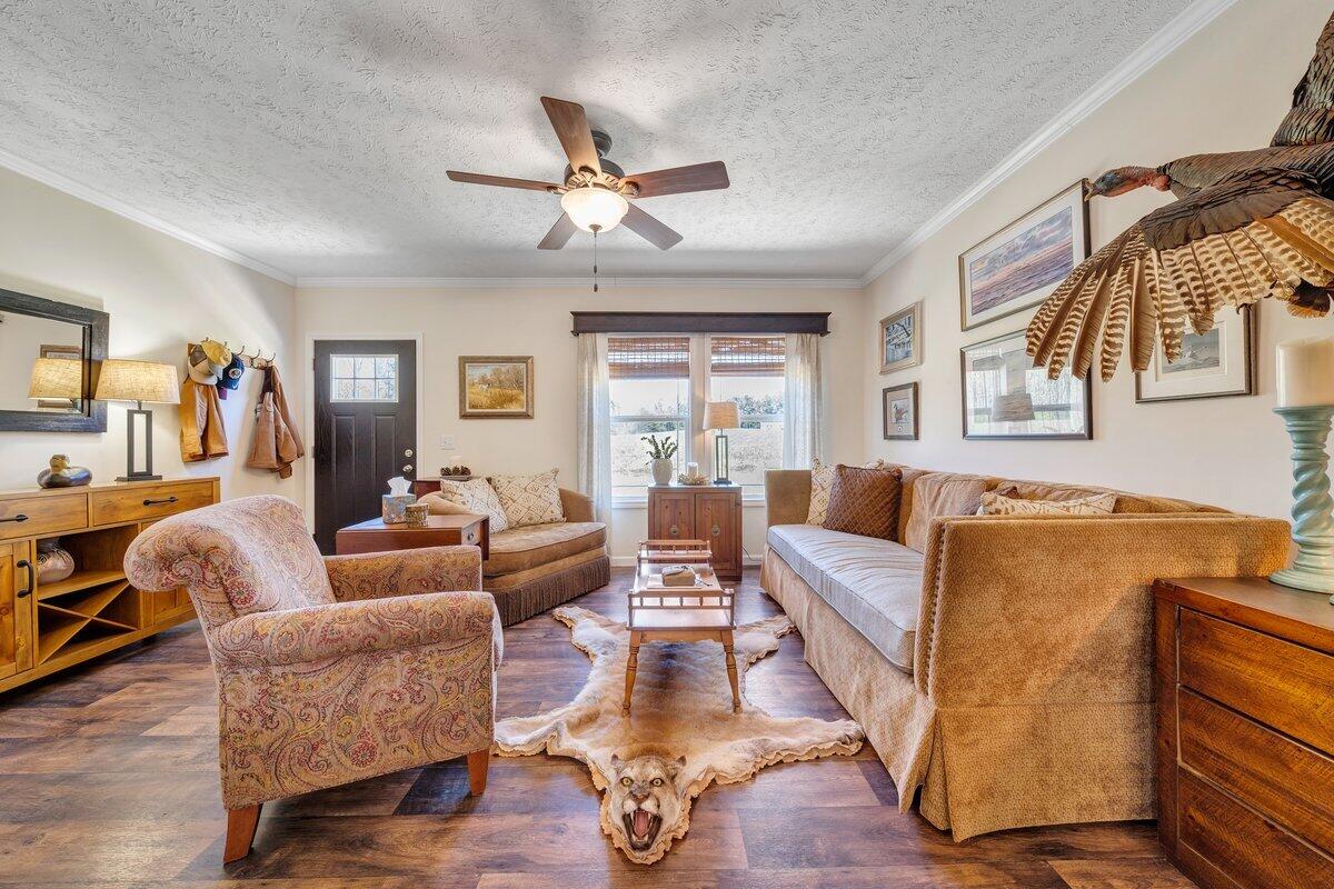 780 Adkins Road Penhook, VA 24137 - Photo 9 of 49 a living room with furniture and a large window