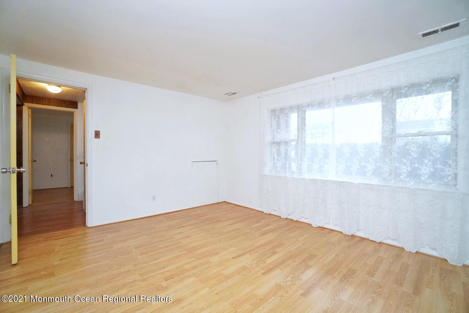 112 Acorn Lane Voorhees, NJ 08043 - Photo 35 of 42 a view of empty room with wooden floor and fan