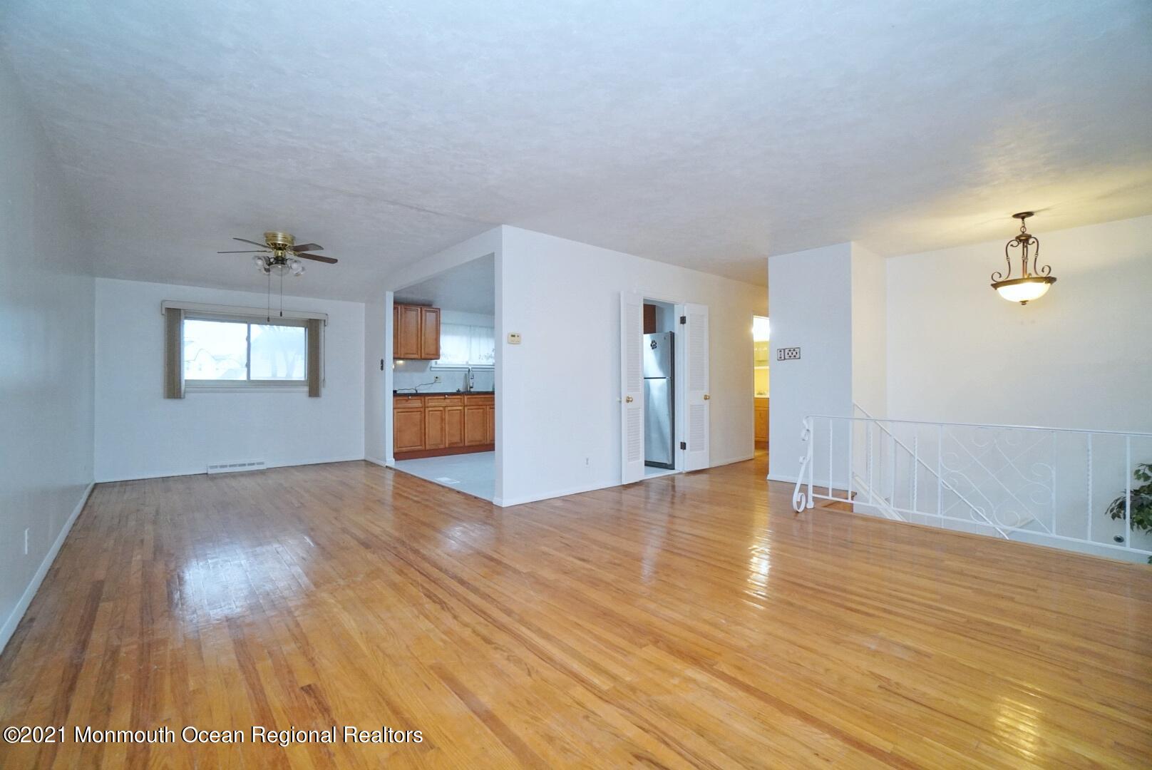112 Acorn Lane Voorhees, NJ 08043 - Photo 10 of 42 a view of empty room with wooden floor and fan