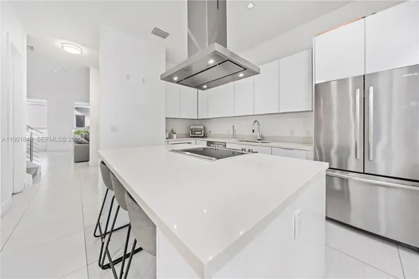 a kitchen with stainless steel appliances a refrigerator sink and stove