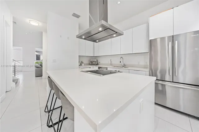 a kitchen with stainless steel appliances a refrigerator sink and stove