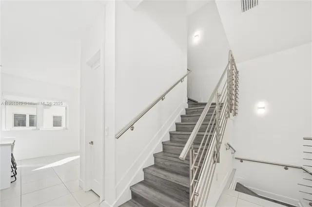 a view of staircase with white walls and windows
