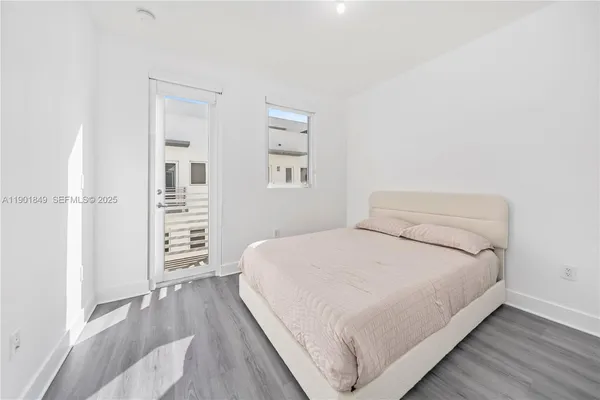 a large bed sitting in a bedroom next to a cabinet with rug