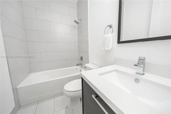 a spacious bedroom with a bed and a flat screen tv