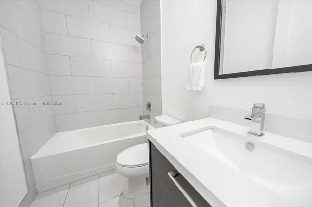 a spacious bedroom with a bed and a flat screen tv