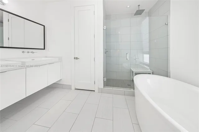 a bathroom with a sink a mirror and vanity