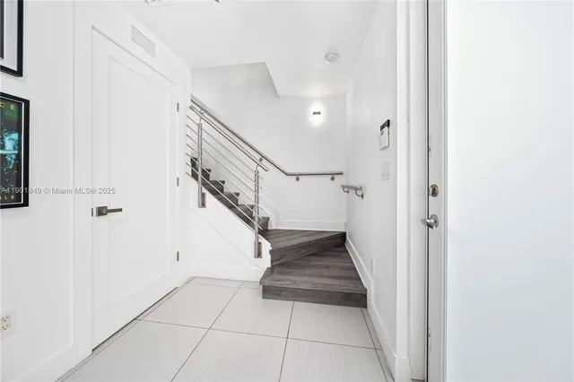 a view of entryway and hall with a front door