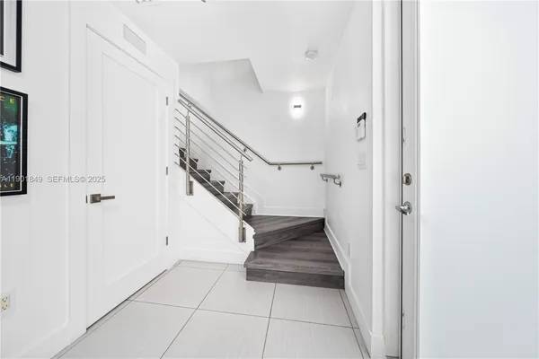 a view of entryway and hall with a front door