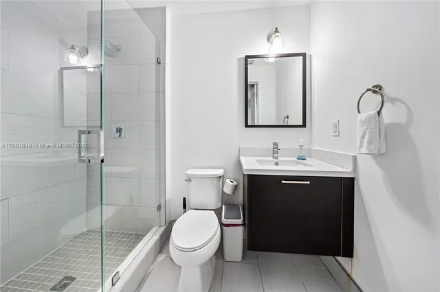 a bathroom with a toilet sink and shower
