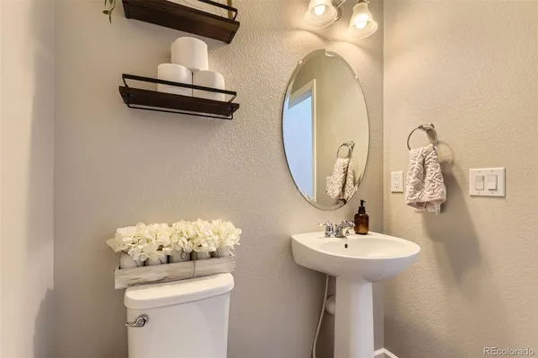 a bathroom with a sink a mirror and toilet