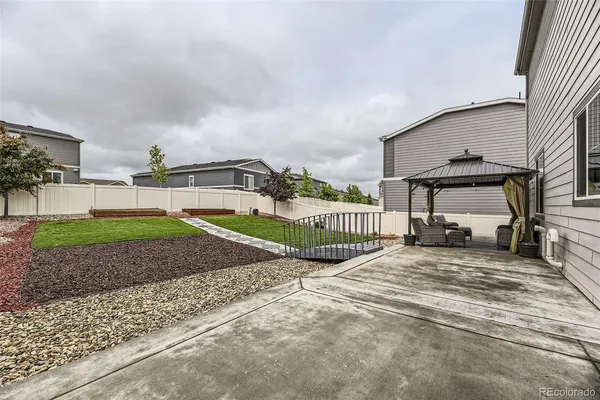a view of a house with a big yard and potted plants