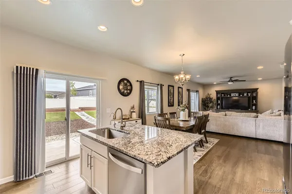 a kitchen with granite countertop a sink and a stove top oven