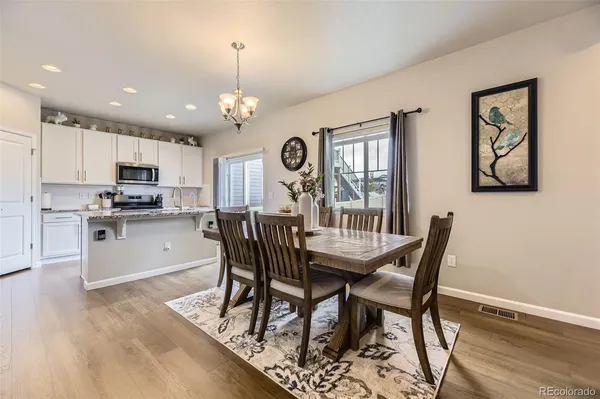 a view of a dining room with furniture and a chandelier