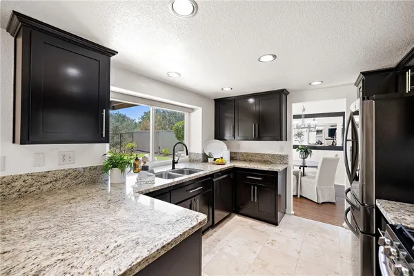 a kitchen with stainless steel appliances granite countertop a stove and a sink