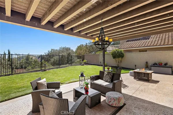 a view of a patio with couches chairs and a yard