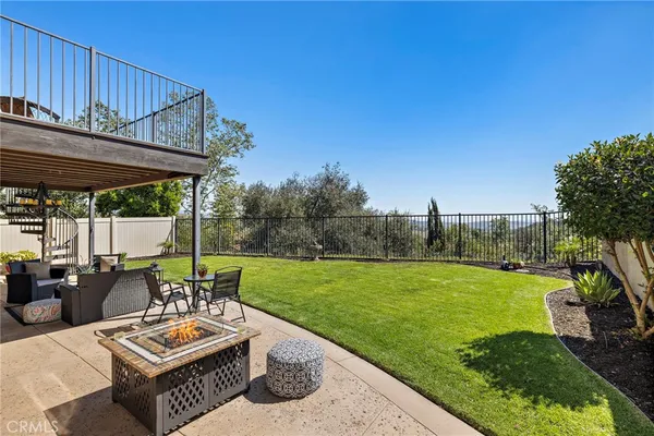a view of a patio with couches chairs and a yard