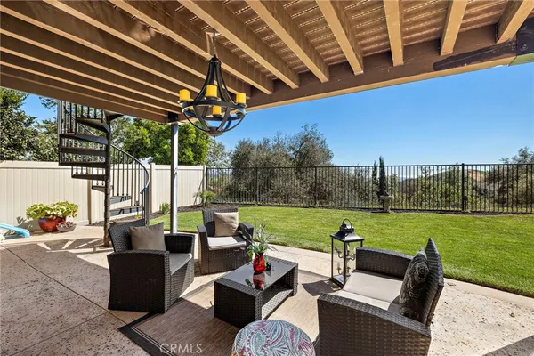 a view of a house with backyard porch and sitting area