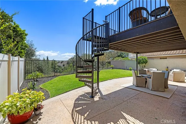 a view of a house with patio and a garden