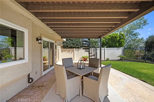 a view of a house with backyard sitting area and porch