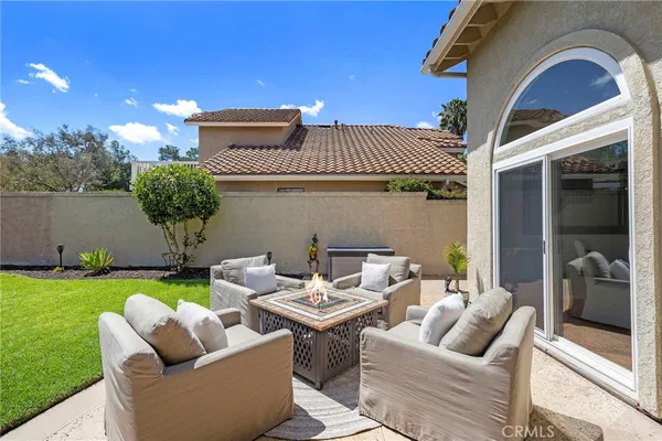 a view of a patio with couches chairs and a yard