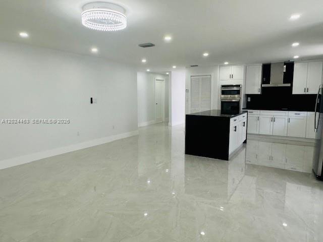11870 Southwest 5th Street, Unit 1 Miami, FL 33184 - Photo 10 of 38 a large white kitchen with a large counter top appliances and cabinets