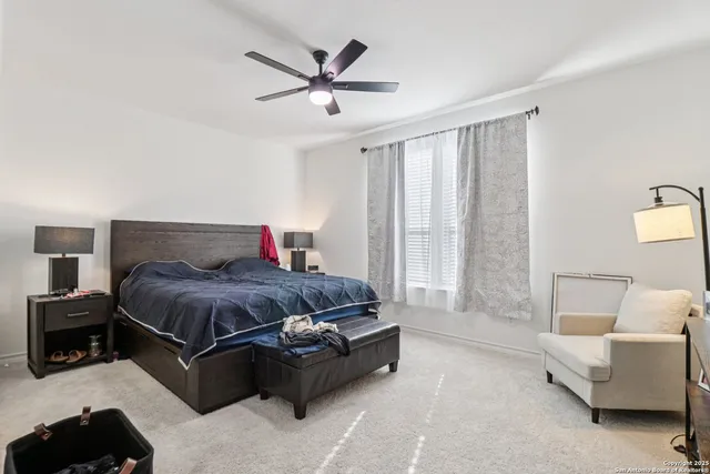 a bedroom with a bed couch and window