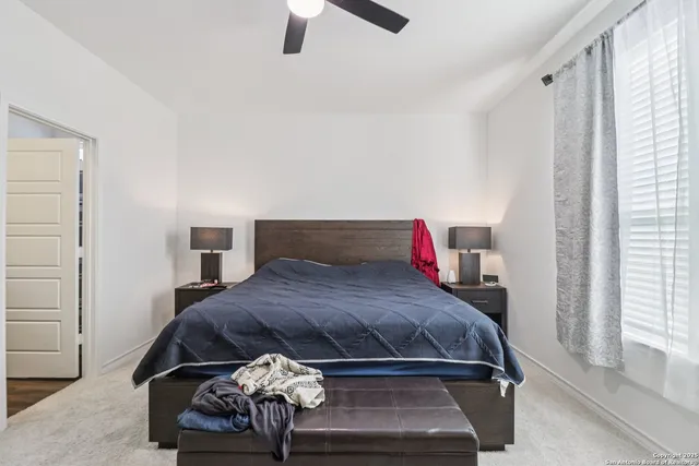 a bedroom with a bed and window