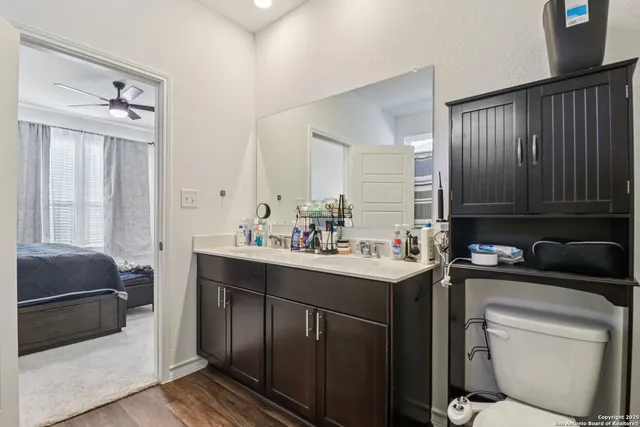 a bathroom with a sink toilet and mirror