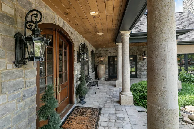 a living room with fireplace furniture and a potted plant