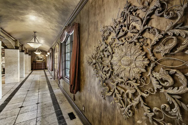 a living room with furniture and a floor to ceiling window