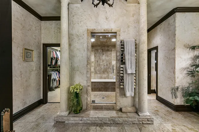 a living room with furniture a flat screen tv and floor to ceiling windows