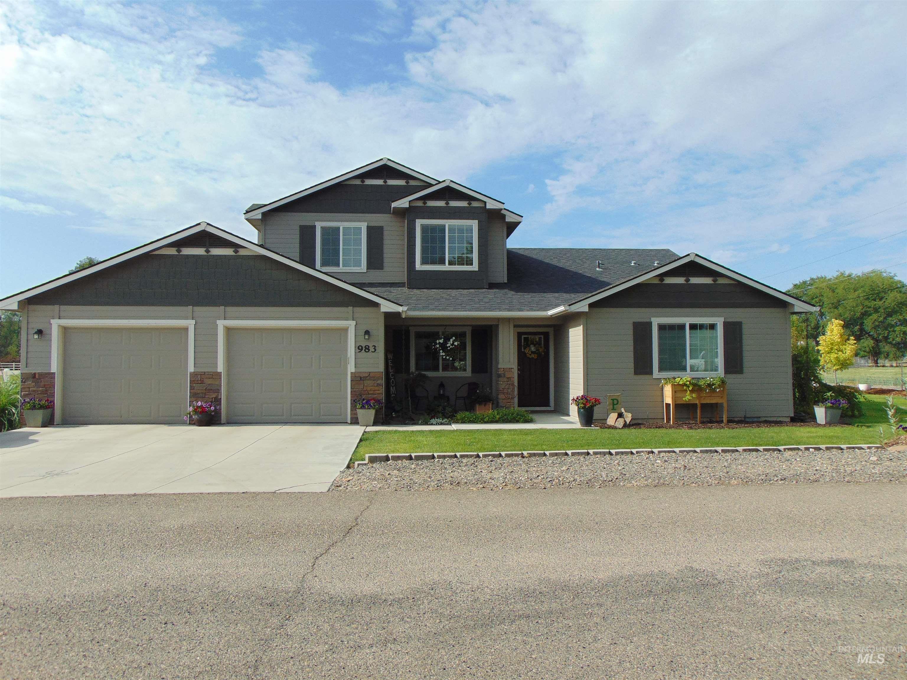 983 South Street Vale, OR 97918 - Photo 2 of 36 Craftsman house featuring an attached garage, concrete driveway, a front lawn, and stone siding