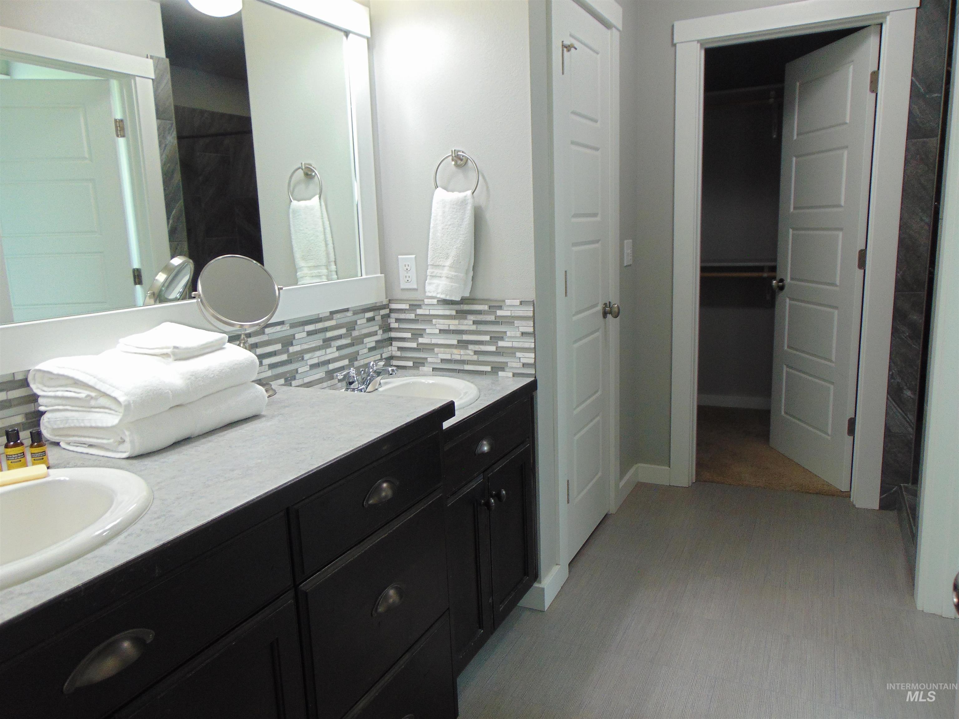 983 South Street Vale, OR 97918 - Photo 23 of 36 Full bathroom with double vanity, a closet, and tasteful backsplash