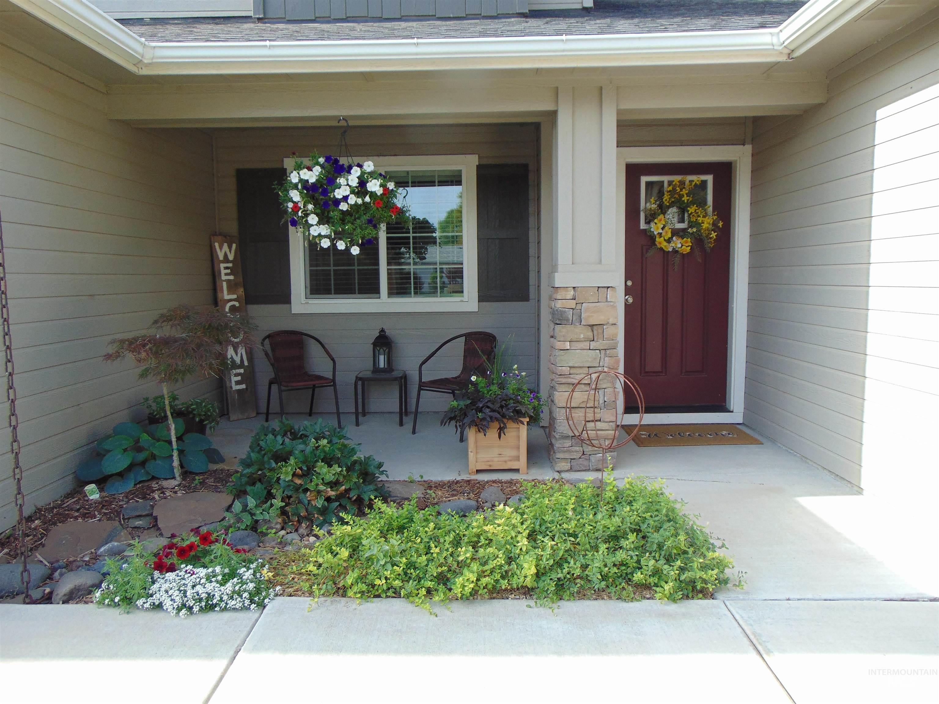 983 South Street Vale, OR 97918 - Photo 3 of 36 Doorway to property featuring covered porch, stone siding, and a shingled roof