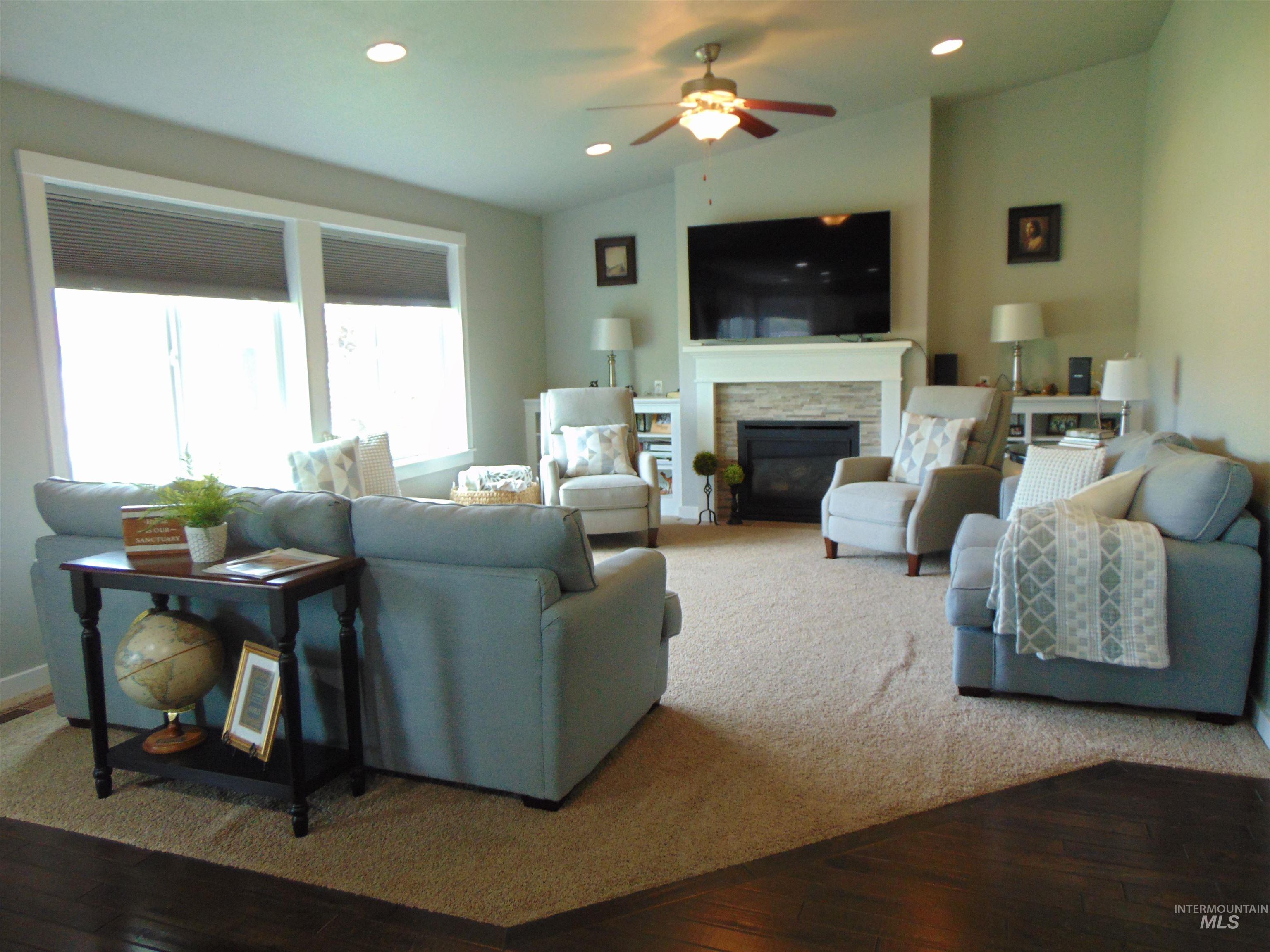 983 South Street Vale, OR 97918 - Photo 10 of 36 Living room with ceiling fan, wood-type flooring, a stone fireplace, recessed lighting, and lofted ceiling