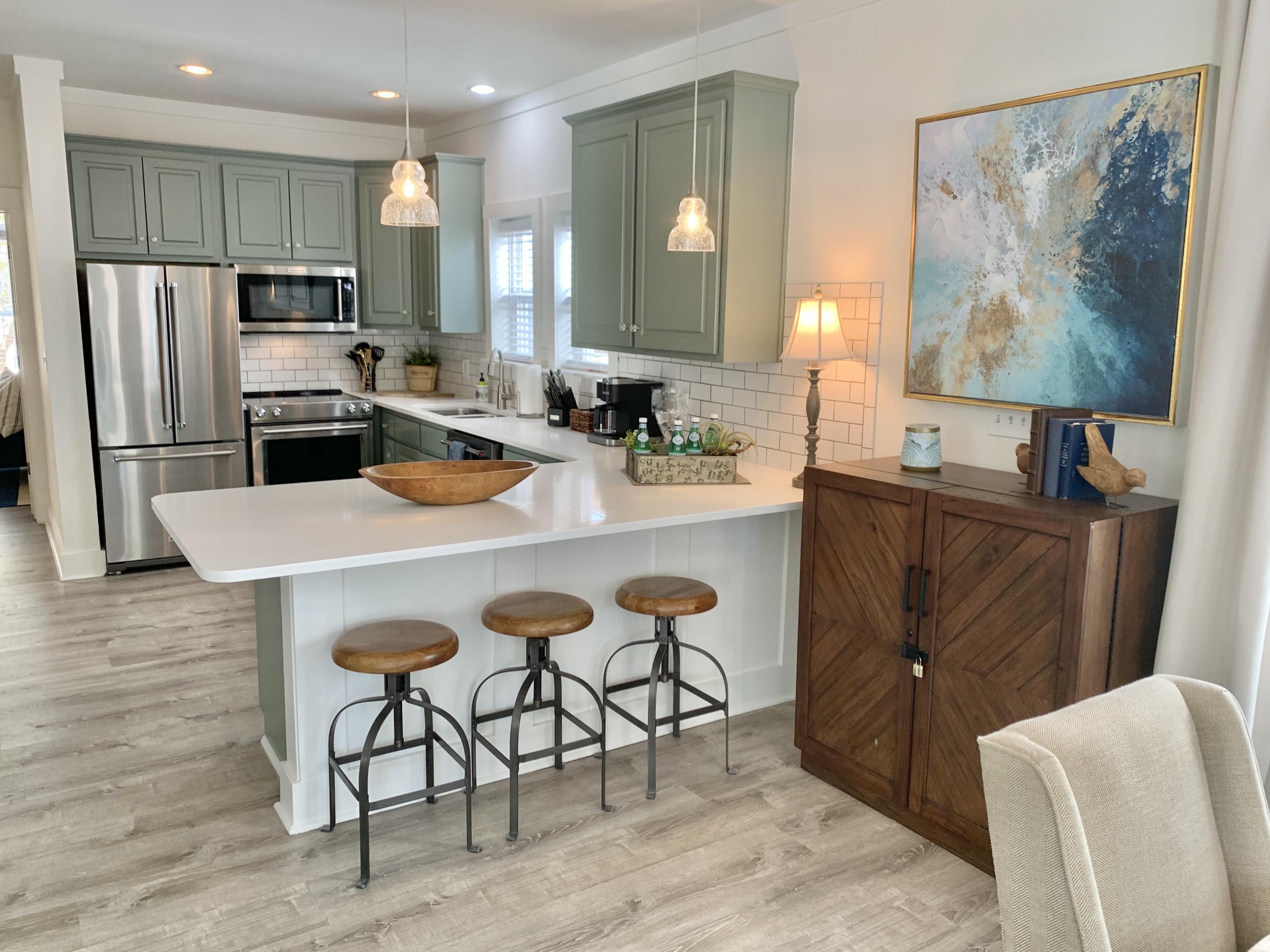 60 The Greenway Loop Inlet Beach, FL 32461 - Photo 13 of 35 a kitchen with granite countertop a refrigerator stove microwave and sink